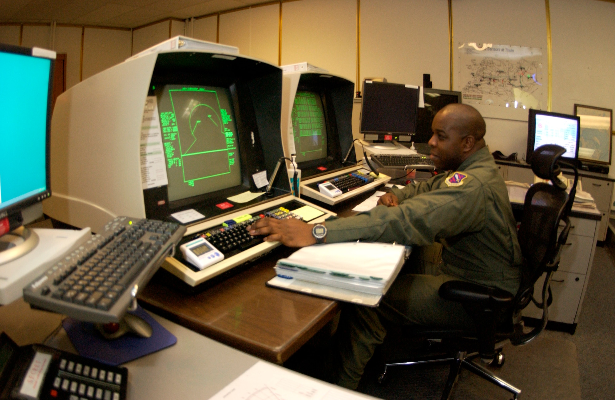 Staff Sgt. Carl White monitors screens that allow him to see objects in space over the northern polar area Jan. 25 at the Ballistic Missile Early Warning System site on Thule Air Base, Greenland. Sergeant White is a space console operator. Airmen serve a one-year remote, unaccompanied tour here in a multinational environment. (U.S. Air Force photo/Michael Tolzmann) 
