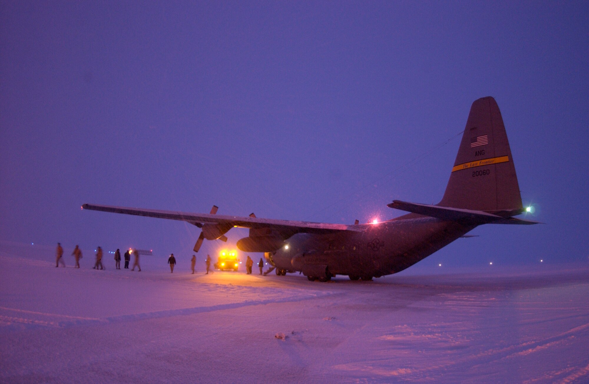 On their way home from Bagram, Afghanistan, Airmen from the Kulis Air National Guard Base, Alaska, exit their C-130 Hercules during a "gas and go" stop Jan. 25 at Thule Air Base, Greenland.  (U.S. Air Force photo/Michael Tolzmann) 
