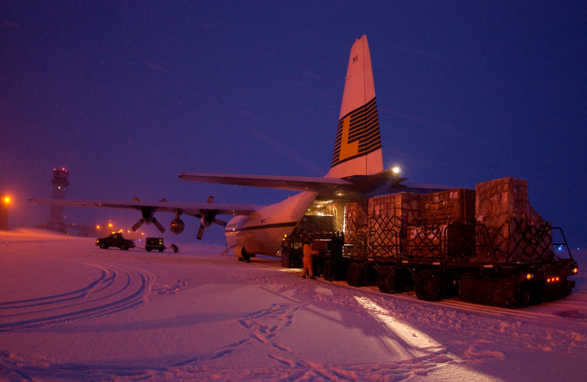 Airmen unload supplies for the base Jan. 25 at Thule Air Base, Greenland. The supplies are flown in on a weekly contracted L-100 aircraft from McGuire Air Force Base, N.J.  (U.S. Air Force photo/Michael Tolzmann) 
