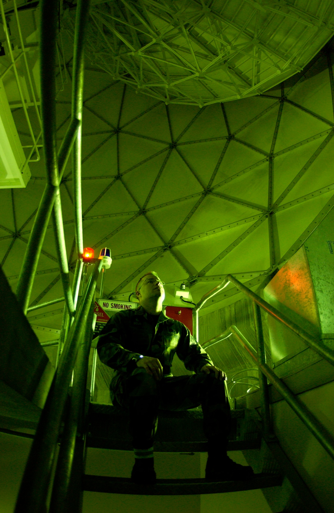 Tech. Sgt. Bryan Schubert watches a moving satellite dish inside one of the "gollf ball" protective dish covers as it tracks a satellite moving across the northern polar sky  Jan. 25 at Detachment 3 on Thule Air Base, Greenland. Thule AB Airmen with two major space missions support the Air Force Space Command mission. Two tenant units contribute to the space mission here. (U.S. Air Force photo/Michael Tolzmann) 
