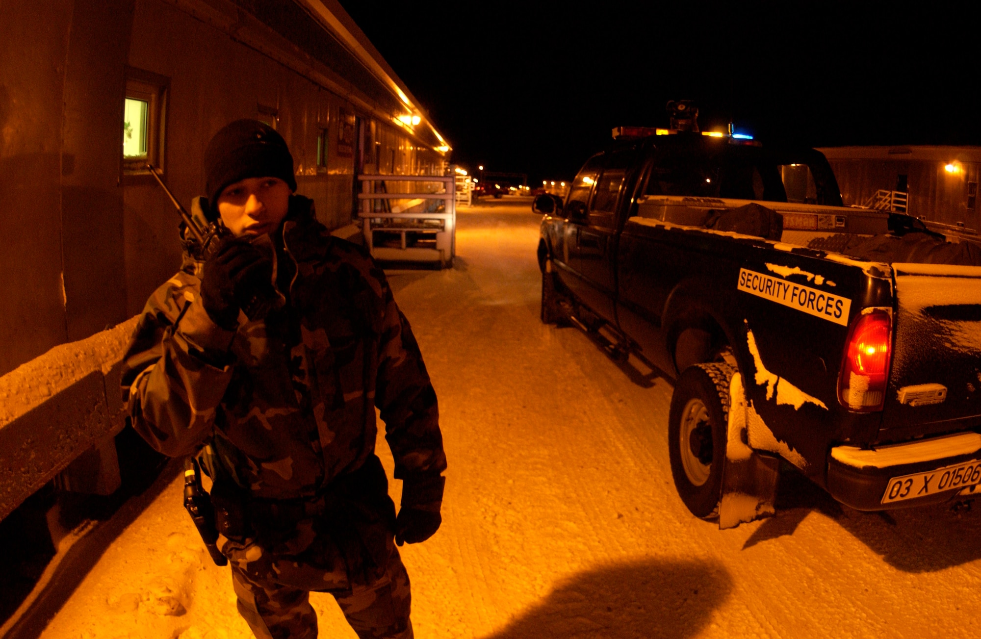 Airman Pedro Pita conducts a building security check as the temperature hovers close to zero Jan. 25 at Thule Air Base, Greenland. Airman Pita is a security forces member at Thule AB. Airmen serve a one-year remote, unaccompanied tour here in a multinational environment. (U.S. Air Force photo/Michael Tolzmann) 
