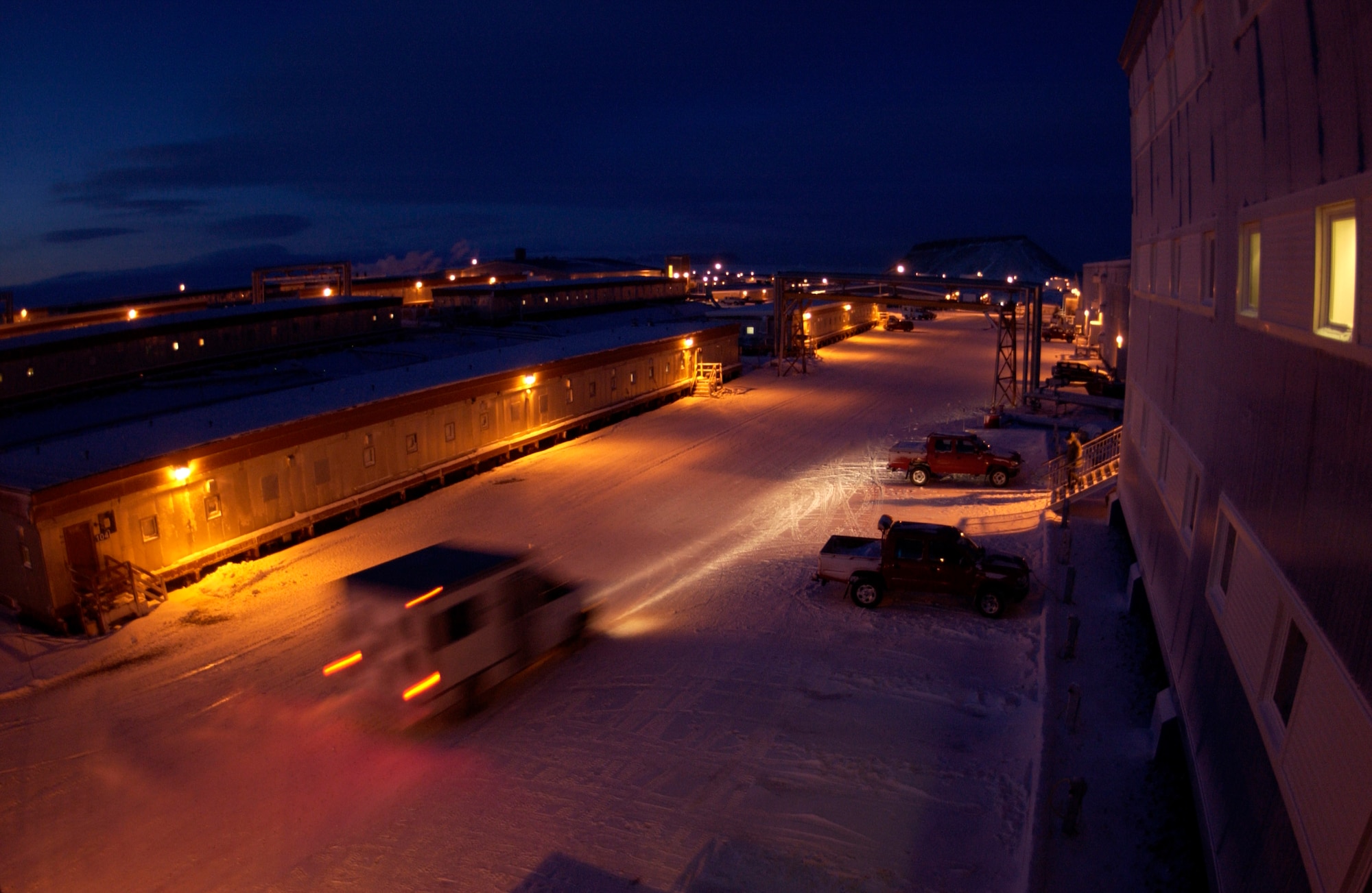 The base taxi arrives at a dormitory to pick up Airmen for work Jan. 25 at Thule Air Base, Greenland. Thule AB Airmen with two major space missions support the Air Force Space Command mission. Two tenant units contribute to the space mission here. (U.S. Air Force photo/Michael Tolzmann) 
