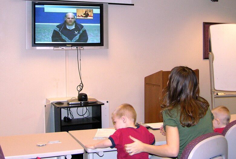 Mandi Crandell and her sons, Trayton and Kade, use the video teleconferencing system in the Airman and Family Readiness Center at Eielson Air Force Base, Alaska, Jan. 13 to communicate with husband and father Airman 1st Class Jonathan Crandell, 354th Civil Engineer Squadron, who is deployed to Iraq. (U.S. Air Force photo/Master Sgt. Daniel Garncarz)