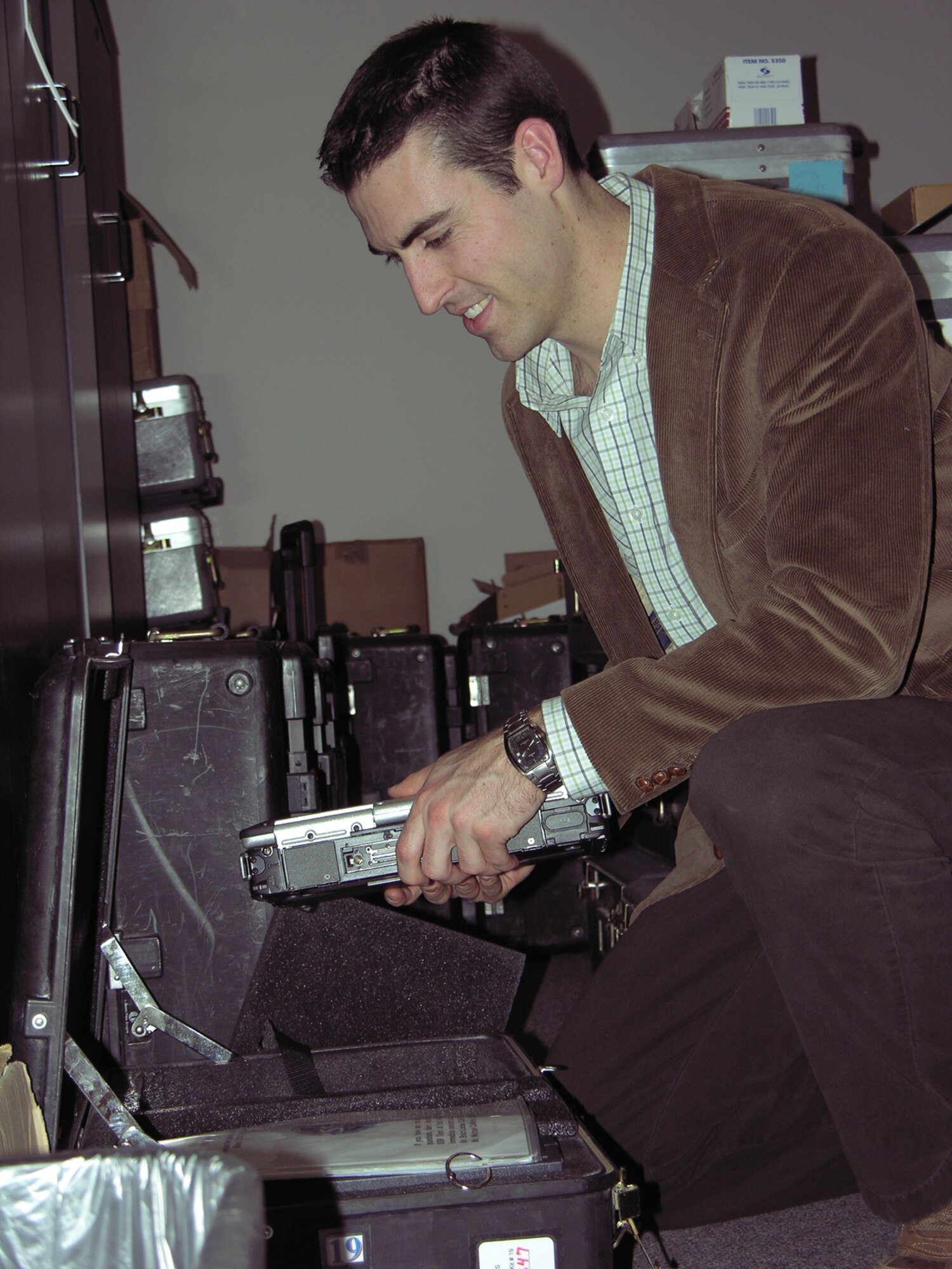 Mike Murphy, a civilian contractor with the 349th ARS, prepares a deployable mission planning kit Jan. 19. Each kit contains a lap top computer, a printer, electronic charts and programs for pilots. (Photo by Master Sgt. Darlene Foote, 22nd ARW Public Affairs)