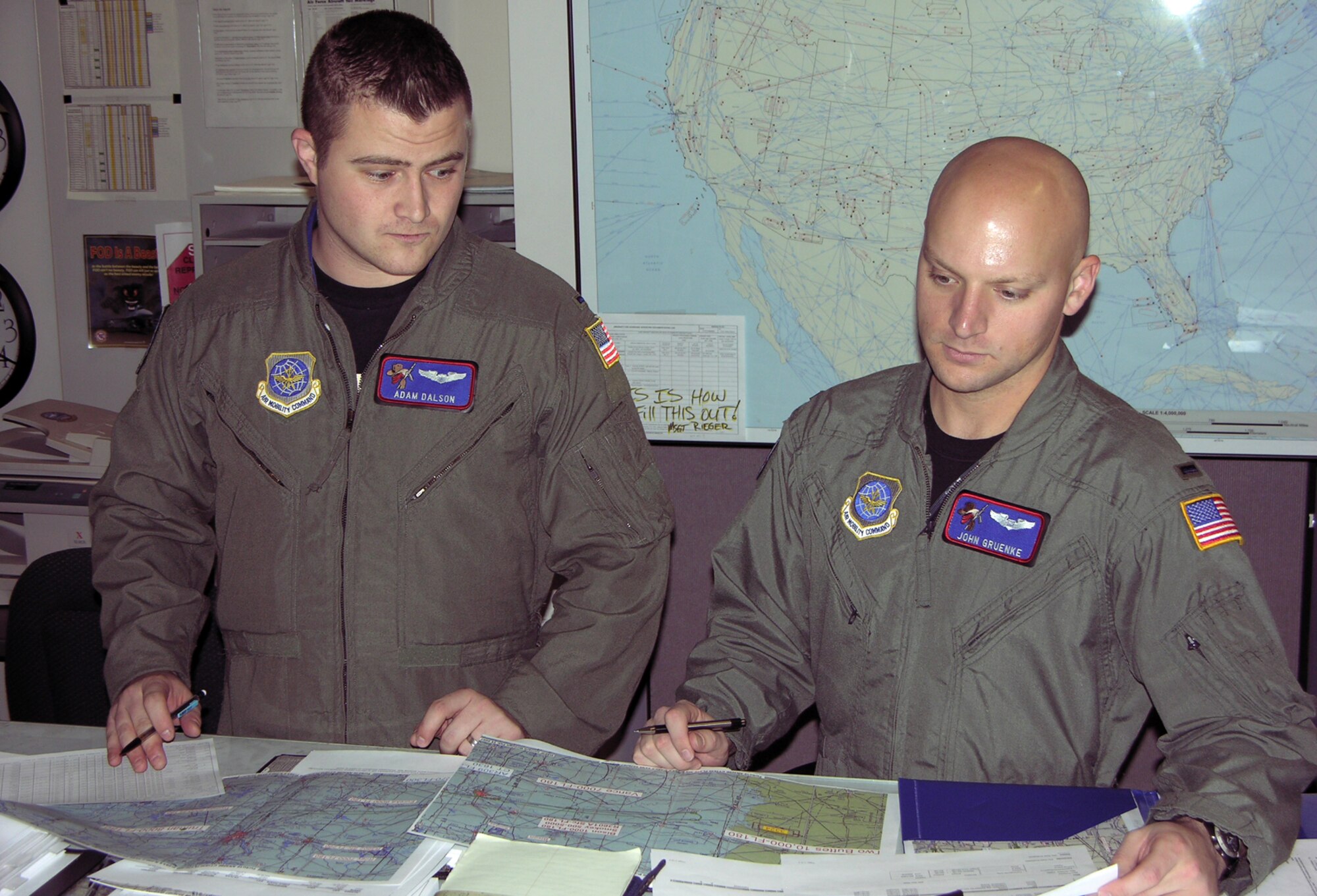 First Lt. Adam Dalson, left, a 349th Air Refueling Squadron pilot, and 1st Lt. John Gruenke, a 349th ARS navigator, review charts and maps, Jan. 19, to plan for an upcoming flying mission. (Photo by Master Sgt. Darlene Foote, 22nd ARW Public Affairs)