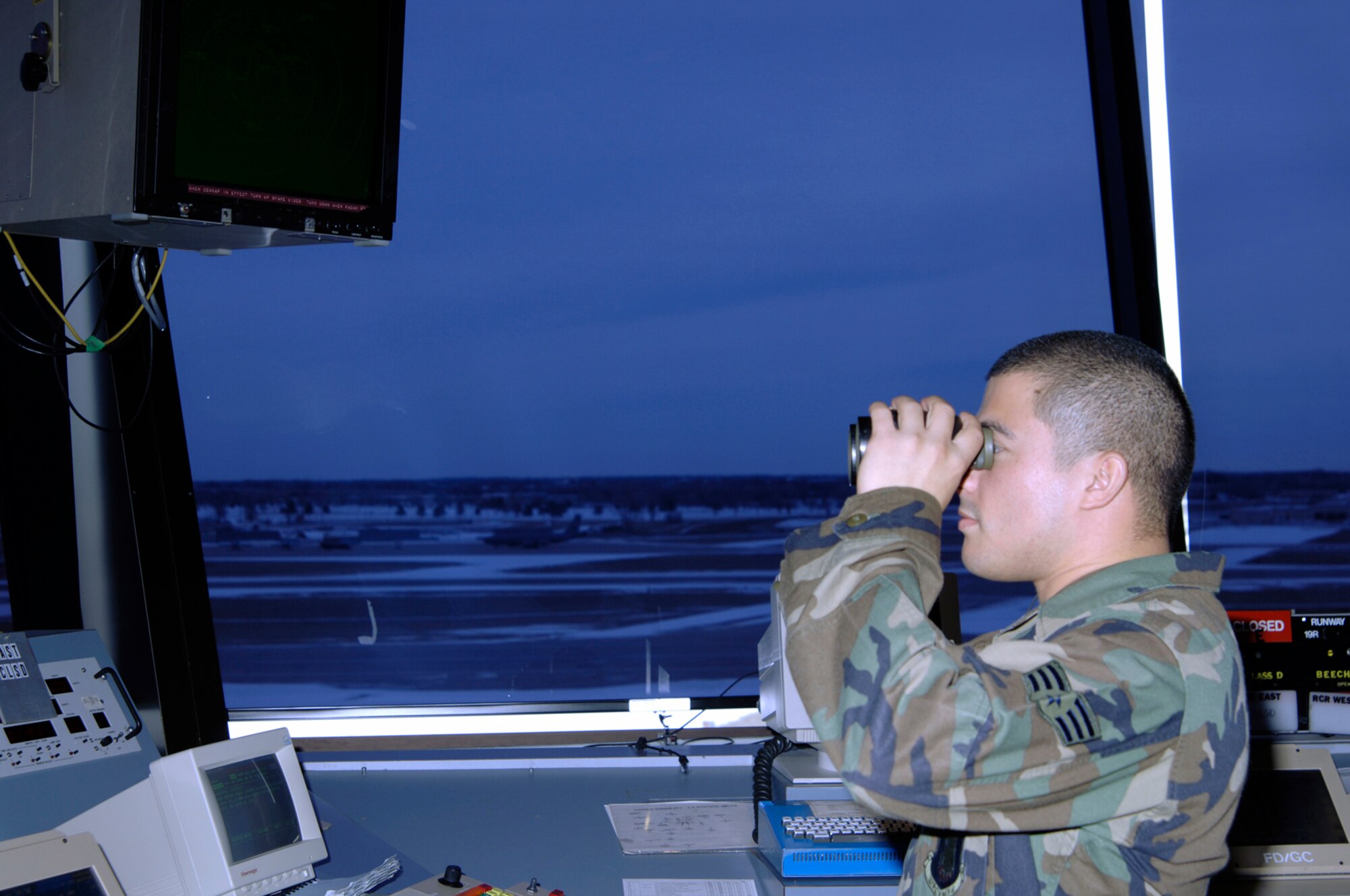 Senior Airman Briant Bell, 22nd Operation Support Squadron air traffic controller, works the air traffic control tower Jan. 18. Air traffic controllers here monitor aircraft in order to prevent accidents. They direct the movement of aircraft into and out of McConnell’s airfield. They track aircraft by radar and relay information to aircrews via radio. They relay flight and landing instructions, weather reports and safety information to pilots.  