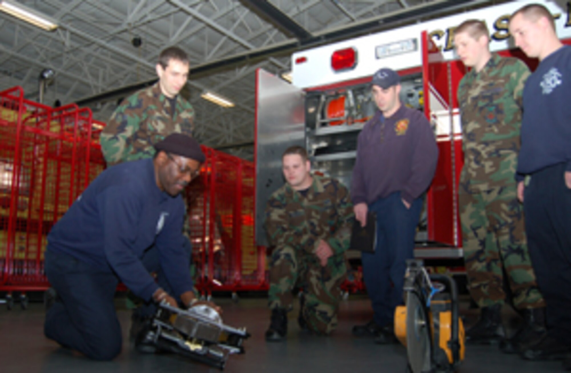 (Left to right) James Cain, 436th Civil Engineer Squadron firefighter, trains fellow fighfighters Airman 1st Class Jeremy Roti, Airman Joseph Wysocki, Tommy Krass, Airman 1st Class Chad Ulman and Donald Dufresne on the Jaws of Life tool. Dover Air Force Base firefighters have made the list of five finalists for the 2006 Mine Safety Appliance Fireslayer of the Year Award. The Dover firefighters are the only team from the Department of Defense to make the finals on this international award. This is the Dover public’s chance to support the fire team that supports the community every day. To vote for the 436th CES fire team, log on to www.msafire.com and click on the link that says “Vote for the 2006 Fireslayer of the Year”. (U.S. Air Force photo/Staff Sgt. Kevin Wallace)