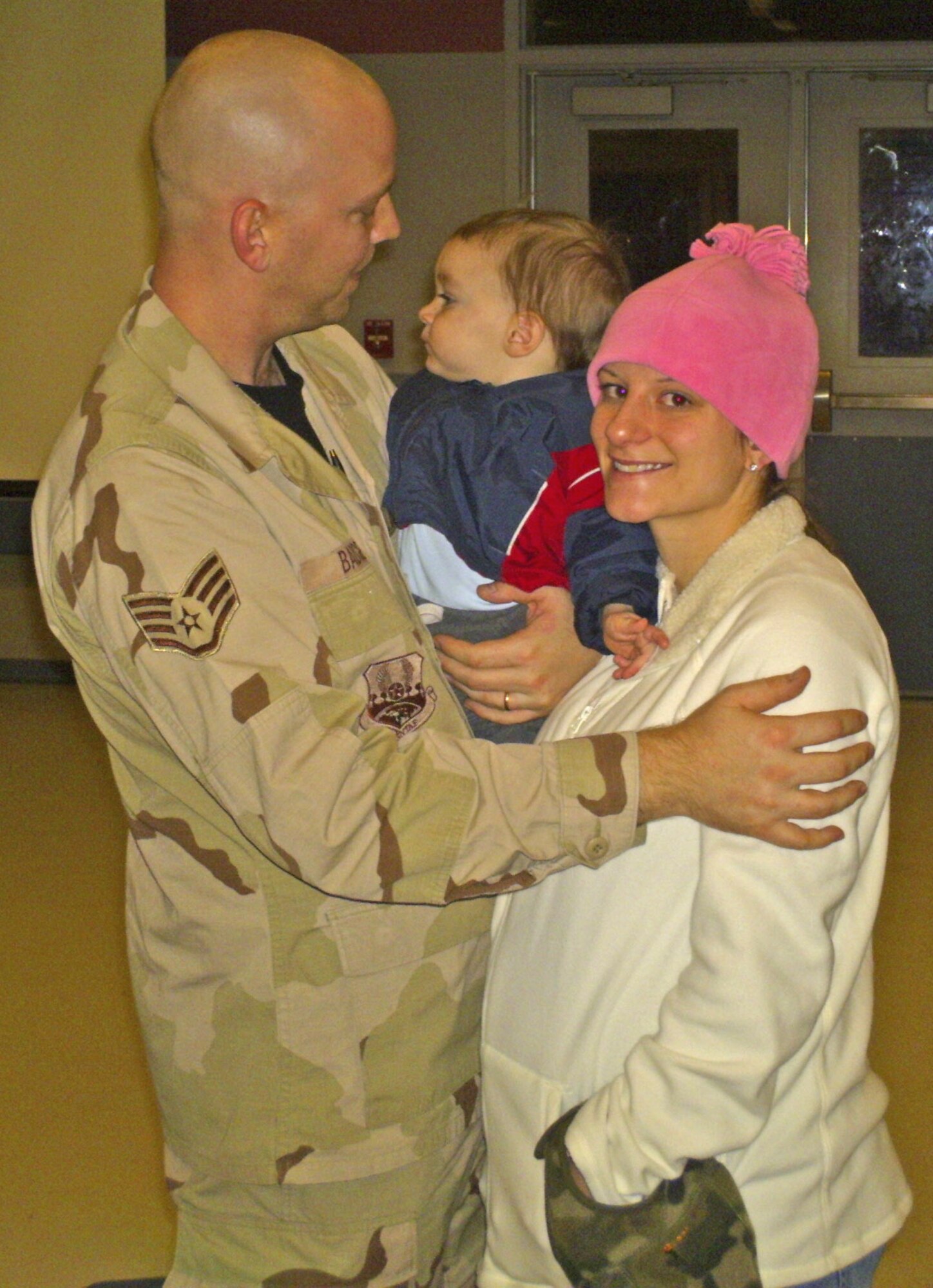 After more than 36 hours on a chartered flight, Staff Sgt. Thomas Badgero is greeted by wife, Rose, and son, Hunter, Jan. 23 at the Joint Mobility Complex at Eielson Air Force Base, Alaska. Sergeant Badgero is assigned to the 354th Logistics Readiness Squadron. (U.S. Air Force photo/Senior Airman Aaron Bonifazi) 