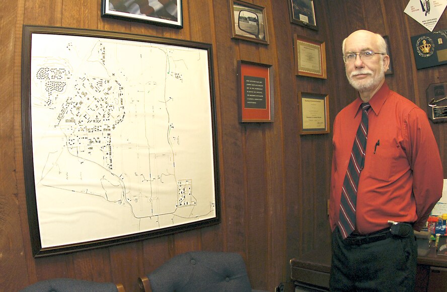 Lowell Klepper, 23rd Civil Engineer Squadron deputy base civil engineer, stands beside a map of the base that has seen many major changes during Mr. Klepper's 27 years at Moody. Mr. Klepper is scheduled to retire Feb. 1, ending a 43-year career as an Air Force civil engineer.
