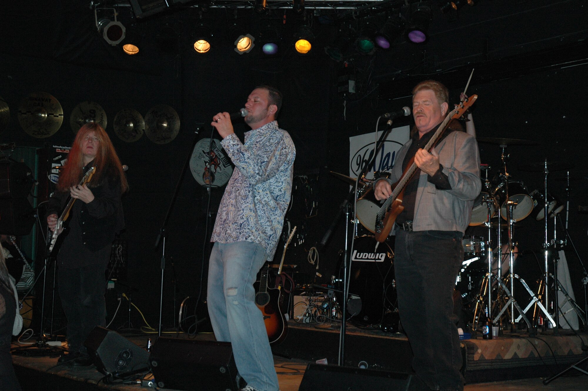 Staff Sergeant Jayson Johnston (center), a reservist with the 315th Aircraft Maintenance Squadron, Charleston AFB, S.C., performs at the Windjammer, Isle of Palms, S.C., with bandmates Geoff Conine (left) and Jerry Ray (right).  The band, Whiskey and Perfume, formed in 2000 and plays at various venues throughout the Lowcountry.  (Photo by Airman 1st Class Dani Pacheco, USAFR)