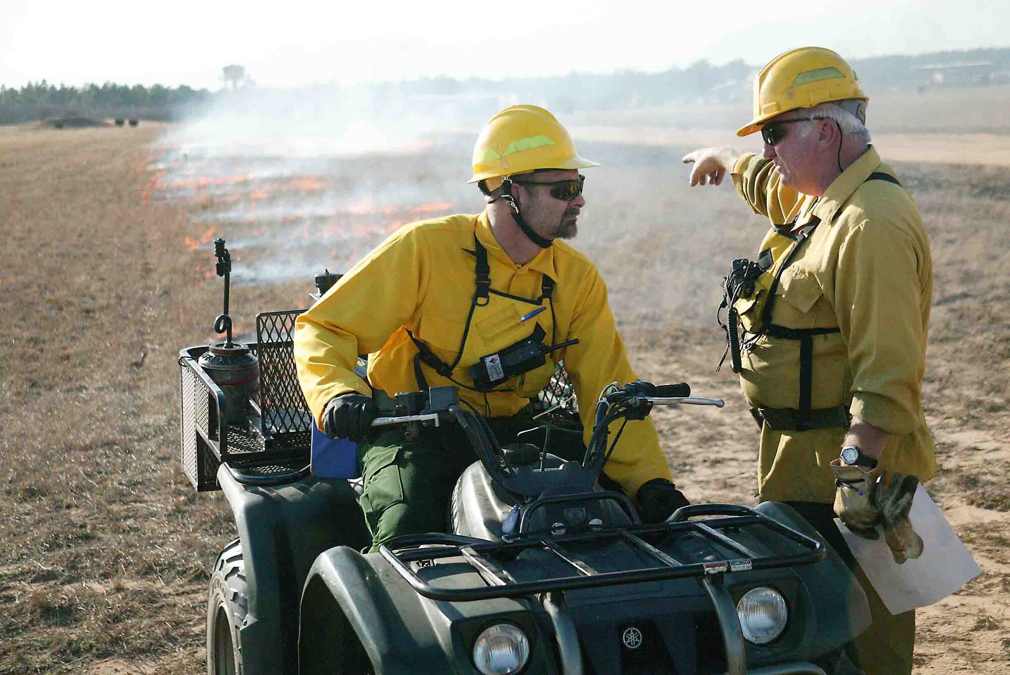 Jimmy Davis (right), 20th Civil Engineer Squadron prescribed fire manager, discusses prescribed fire plans with Dave Davis, 20th CES wildlife biologist, at the Poinsett Electronic Combat Range. Fuel reduction was the purpose of the Jan. 12 prescribed fire. (U.S. Air Force photo/Senior Airman John Gordinier)