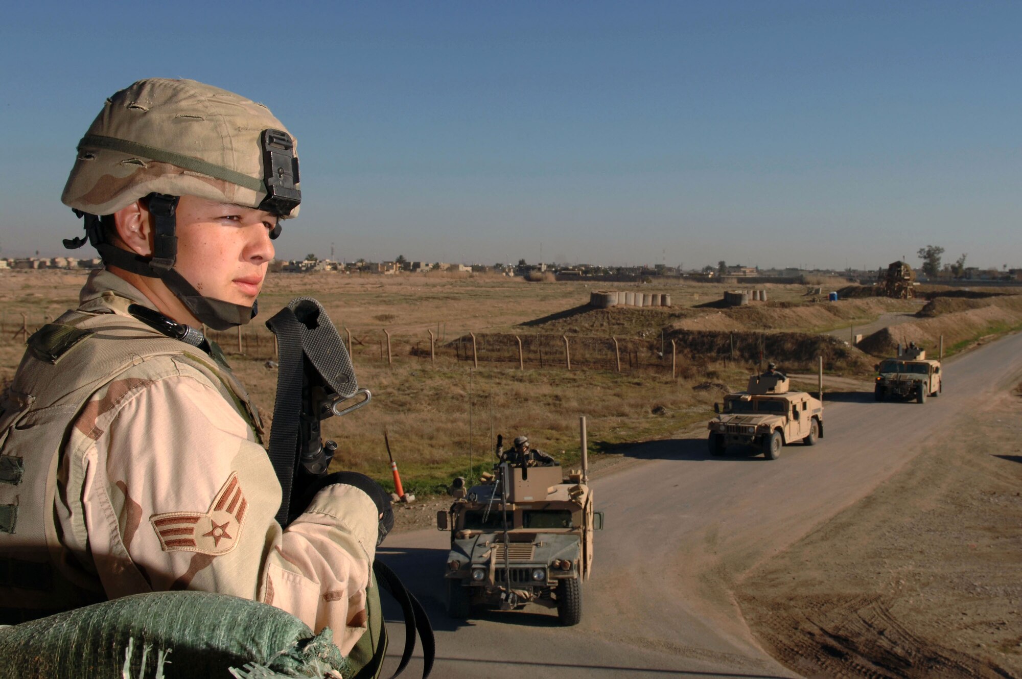 Senior Airman Richard Rodriguez checks the perimeter for insurgents as Army convoys come back from patrols Jan. 24 at Kirkuk Regional Air Base, Iraq. Airman Rodriguez is a 506th Expeditionary Security Forces Squadron perimeter guard who is deployed from the 5th SFS at Minot Air Force Base, N.D. (U.S. Air Force photo/Senior Airman Bradley A. Lail)