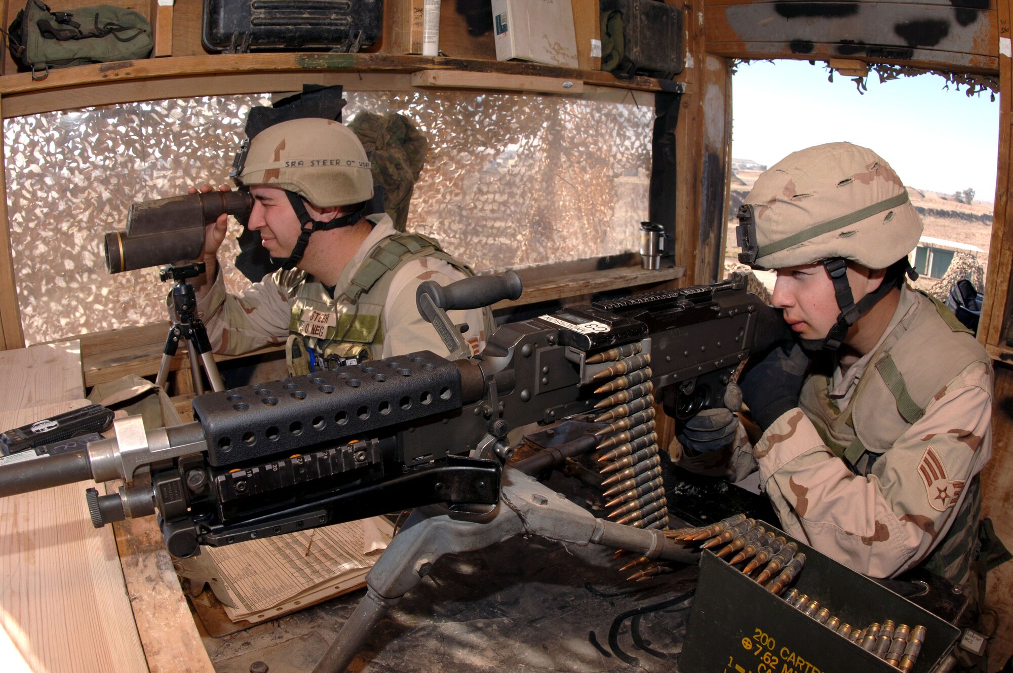 Senior Airman Mathew Steer and Senior Airman Richard Rodriguez monitor vehicles closely at an entry control point Jan. 24 at Kirkuk Regional Air Base, Iraq. Both are Kirkuk Air Base perimeter guards for the 506th Expeditionary Security Forces Squadron. (U.S. Air Force photo/Senior Airman Bradley A. Lail) 