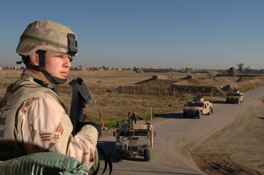 KIRKUK REGIONAL AIR BASE, IRAQ -- Senior Airman Richard Rodriguez, 506th Expeditionary Security Forces Squadron, checks the perimeter for insurgents here Jan. 24 as coalition convoys return from a patrol. Airman Rodriguez is deployed here from the 5th Security Forces Squadron at Minot Air Force Base, N.D.(U.S. Air Force photo by Senior Airman Bradley A. Lail)