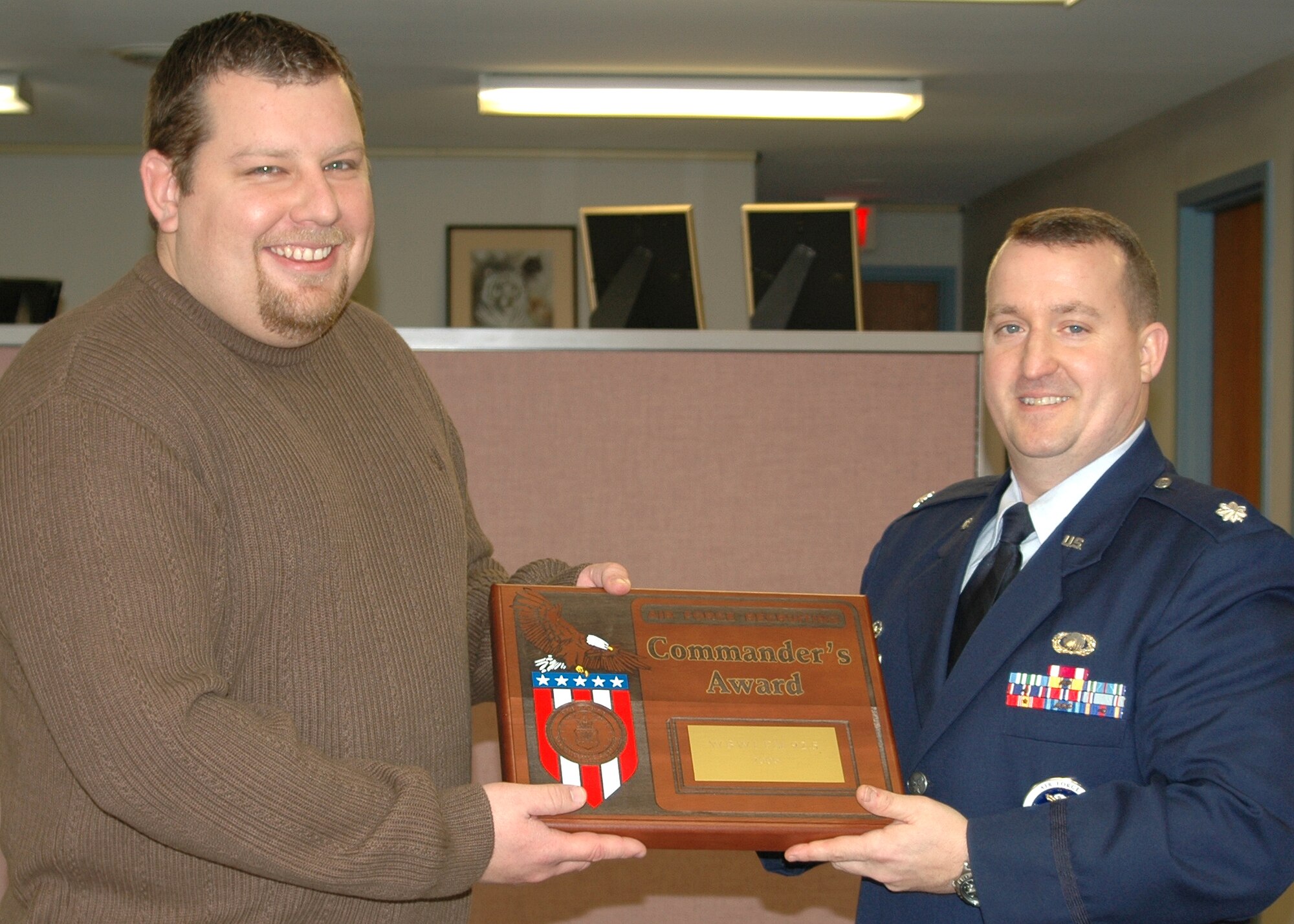 Lt. Col. Ronald Jackson, 347th Recruiting Squadron commander, presents Fuzz Martin, left, WBWI 92.5 FM program director, the Air Force Recruiting Service Commander’s Award. (U.S. Air Force photo by Staff Sgt. Holly Schwartz)