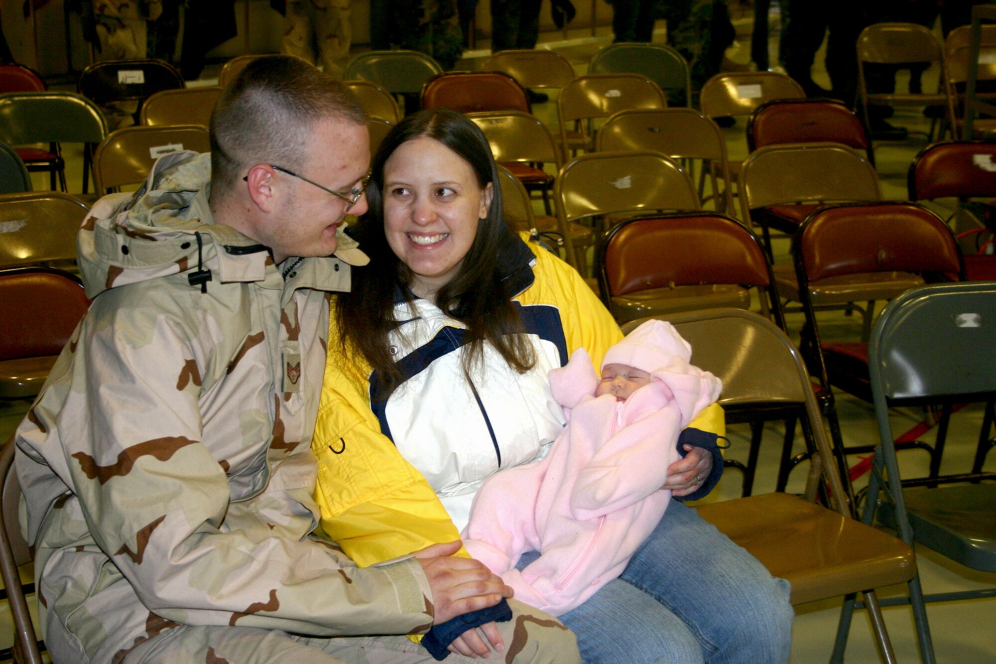Staff Sgt. Jason DeRocha, 27th Equipment Maintenance Squadron, spends time with his wife Sarah and his two-month old daughter Jessica shortly after his return to Cannon Air Force Base, N.M. from Balad Air Base, Iraq Jan. 18. Sergeant DeRocha was one of nearly 300 Cannon Airmen who returned from a four-month deployment to Iraq as members of Air Expeditionary Force 3/4. (Air Force photo/Greg Allen)