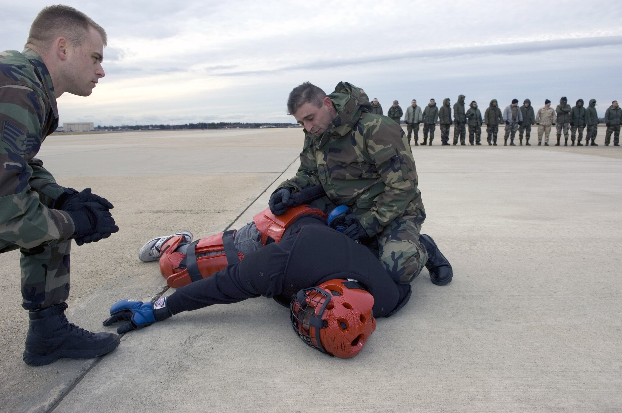 Staff Sgt. Jason Taylor oversees a student subduing an intruder during anti-hijacking training as part of the Fly Away Security Training Course 07-1 Jan. 16 at McGuire Air Force Base, N.J. Sergeant Taylor is an instructor with the 421st Combat Training Squadron of the Air Mobility Warfare Center at Fort Dix, N.J. This was the first FAST course taught by the AMWC to prepare the students prior to their departure for deployment to Iraq. (U.S. Air Force photo/Kenn Mann)

