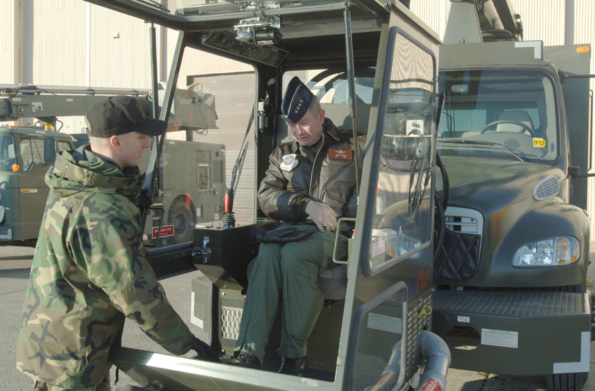 Gen. Duncan McNabb, Air Mobility Command commander, is briefed by Senior Airman Jason Bales, 319th Aircraft Maintenance Squadron, on the squadron's snow removal machinery during his visit Jan. 20. (photo/Airman 1st Class SerMae Lampkin)
