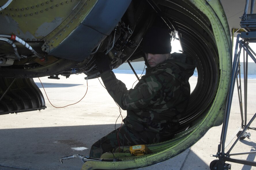 MINOT AIR FORCE BASE, N.D. -- Staff Sgt. Justin Mcnichols, 5th Aircraft Maintenance Squadron, checks an engine of a B-52H Stratofortress Jan. 19. The B-52H engines are being tested to measure the difference between the use of JP-8 fuel, which the B-52 is accustomed to, verses Fischer-Tropsch, a synthetic fuel. The testing of synthetic fuel in cold weather is the last step in the certification process to help reduce Air Force dependence on imported fuel. (U.S. Air Force photo by Airman 1st Class Joe Rivera)