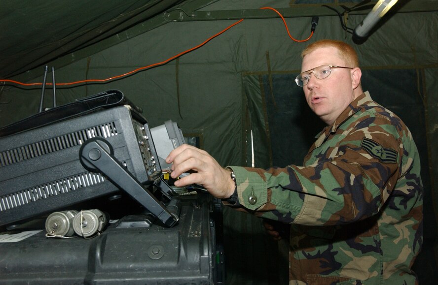 OSAN AIR BASE, Republic of Korea --  Staff Sgt. Erik Knippa, 607th Combat Communications Squadron, monitors the computer system inside the deployed tactical satellite shop Dec. 1. (U.S. Air Force photo by Senior Airman Eunique Stevens)