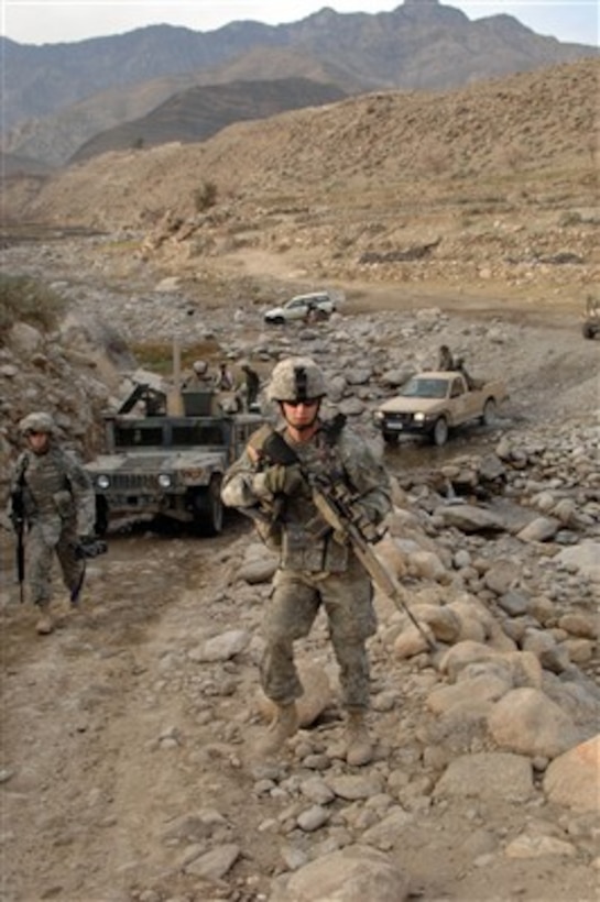 U.S. Army soldiers from the 1st Battalion, 102nd Infantry Regiment, Connecticut National Guard and Afghanistan National Army soldiers from 3rd Battalion, 3rd Brigade, 201st Corp, patrol a road outside of Forward Operating Base Kalagush, Afghanistan, on Jan. 9, 2007.  