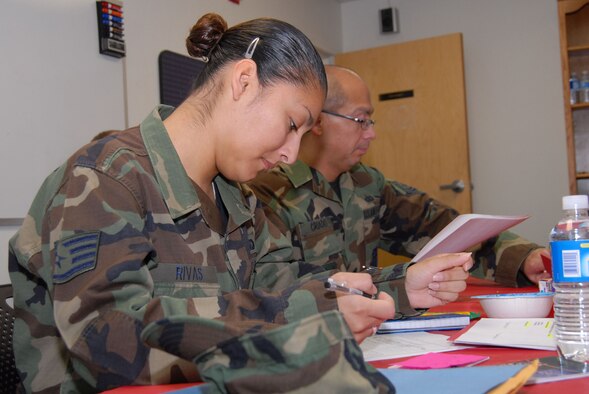 Staff Sgt. Caprice Rivas and Tech. Sgt. Antonio Criado, both from the 95th Mission Support Group, fill out the post deployment checklist at the Airman and Family Readiness Center on Jan. 22, 2007. The post-deployment checklist is part of the new Reunion and Reintegration Program at the Airman and Family Readiness Center. (Photo by Airman 1st Class Julius Delos Reyes)