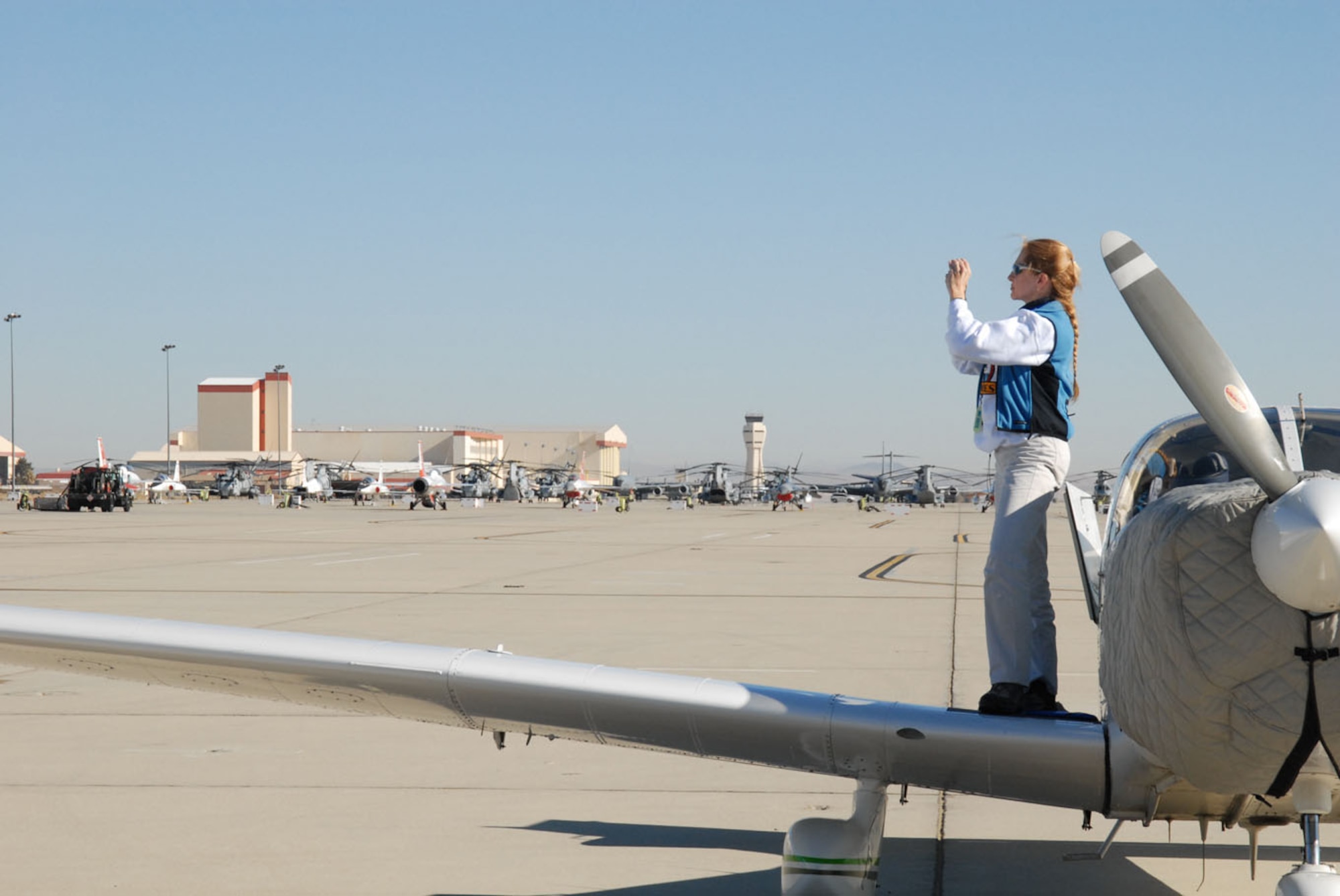Retired Lt. Col. Karen Kaylor, Ninety-Nines member, takes photographs of the base’s scenery during the organization’s fly-in here Jan. 20, 2007. The Ninety-Nines are comprised of 65 members who reside in Ventura County, Calif. (Photo by Airman 1st Class Julius Delos Reyes)