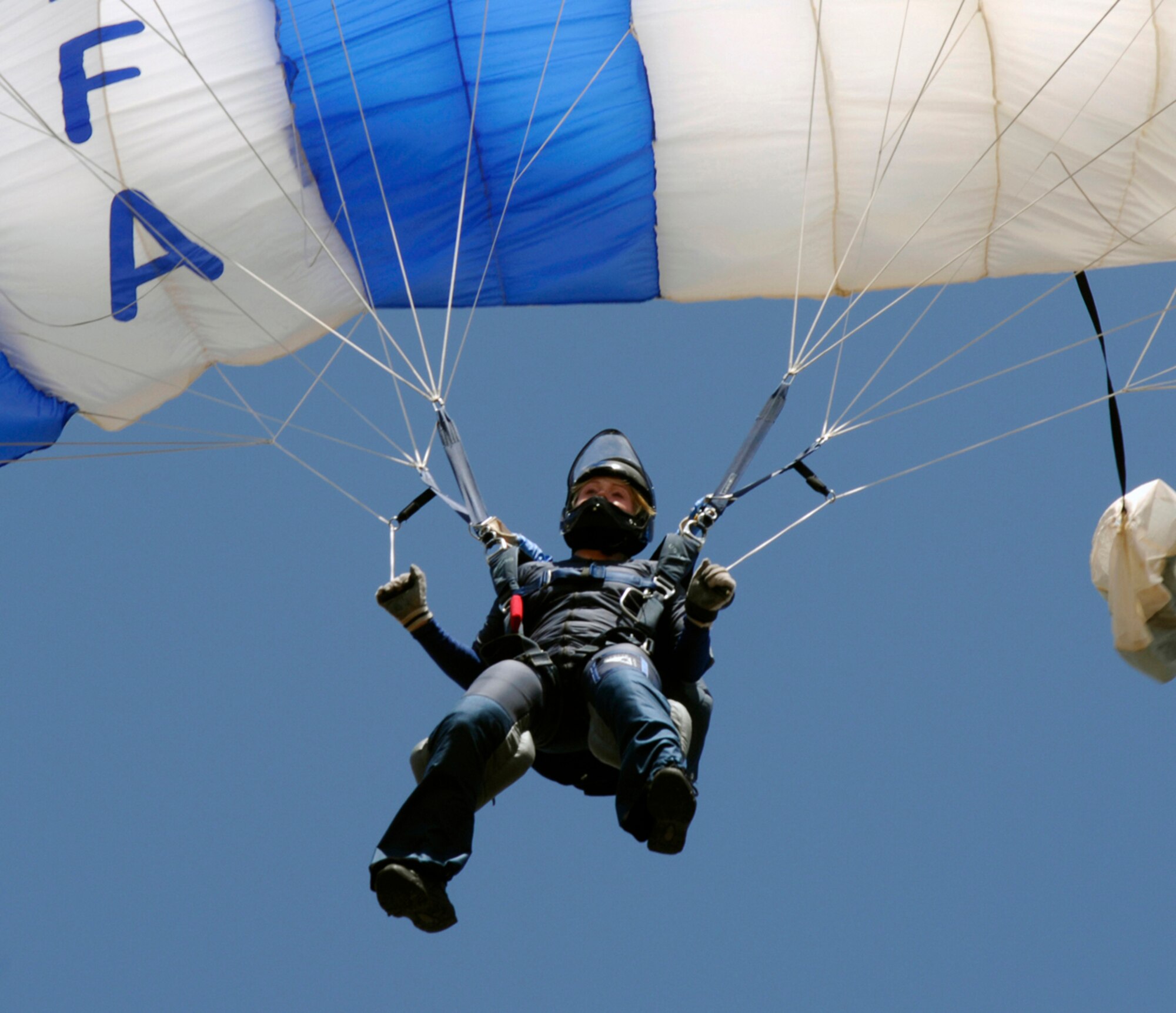 United States Air Force Academy Cadet Caroline White, an AM-490 jump instructor for the 98th Flight Training Squadron, prepares to land after making sure all of trainees land correctly July 20, 2006. The academy's AM 490 jump training course is roughly an eight day course with three to four days of grueling ground training followed by the students getting in Twin Otter airplanes and putting their new skydiving skills to the test in the air. (United States Air Force Photo by SSgt. Matthew Hannen)