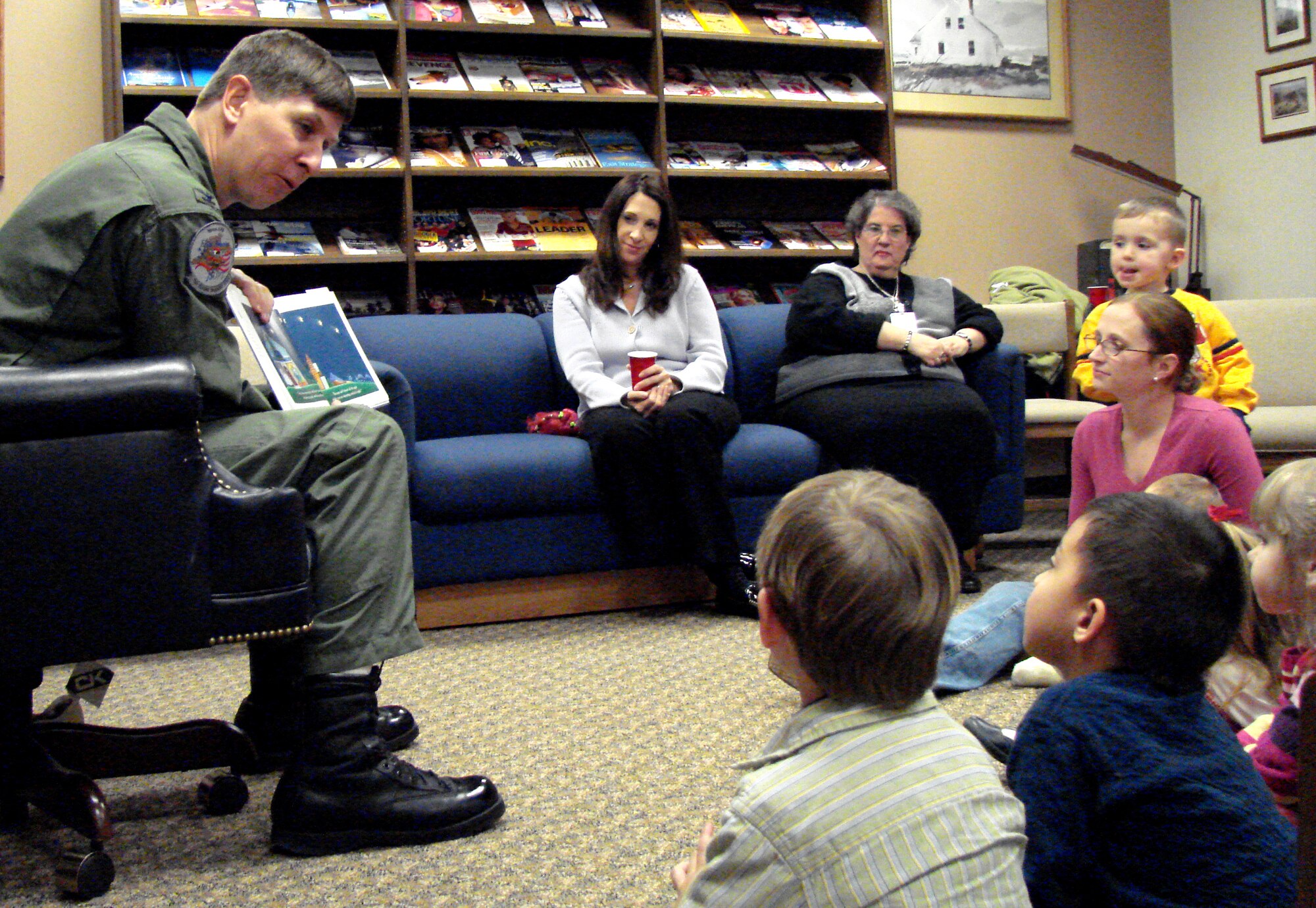 Col. Richard Klumpp, Jr., 71st Flying Training Wing commander, reads “Night Catch” to some of team Vance’s younger members during Family Night at the Vance AFB library Tuesday. In addition to reading the book about families dealing with deployments, the colonel also shared his deployment experiences with the audience. (Photo by 2nd Lt. James Justice)