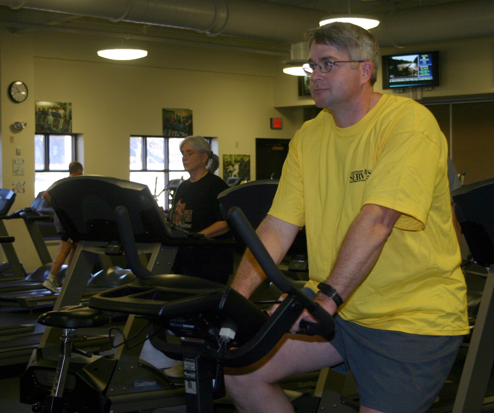 Michael Pierce, a retired senior master sergeant, now working as a course supervisor with the 82nd Medical Operations Squadron, bikes at the Pitsenbarger Fitness Center Thursday. Mr. Pierce recently became the first Team Sheppard member to complete the 82nd Services Division's "Tour de Sheppard." (Airman 1st Class Jacob Corbin.)