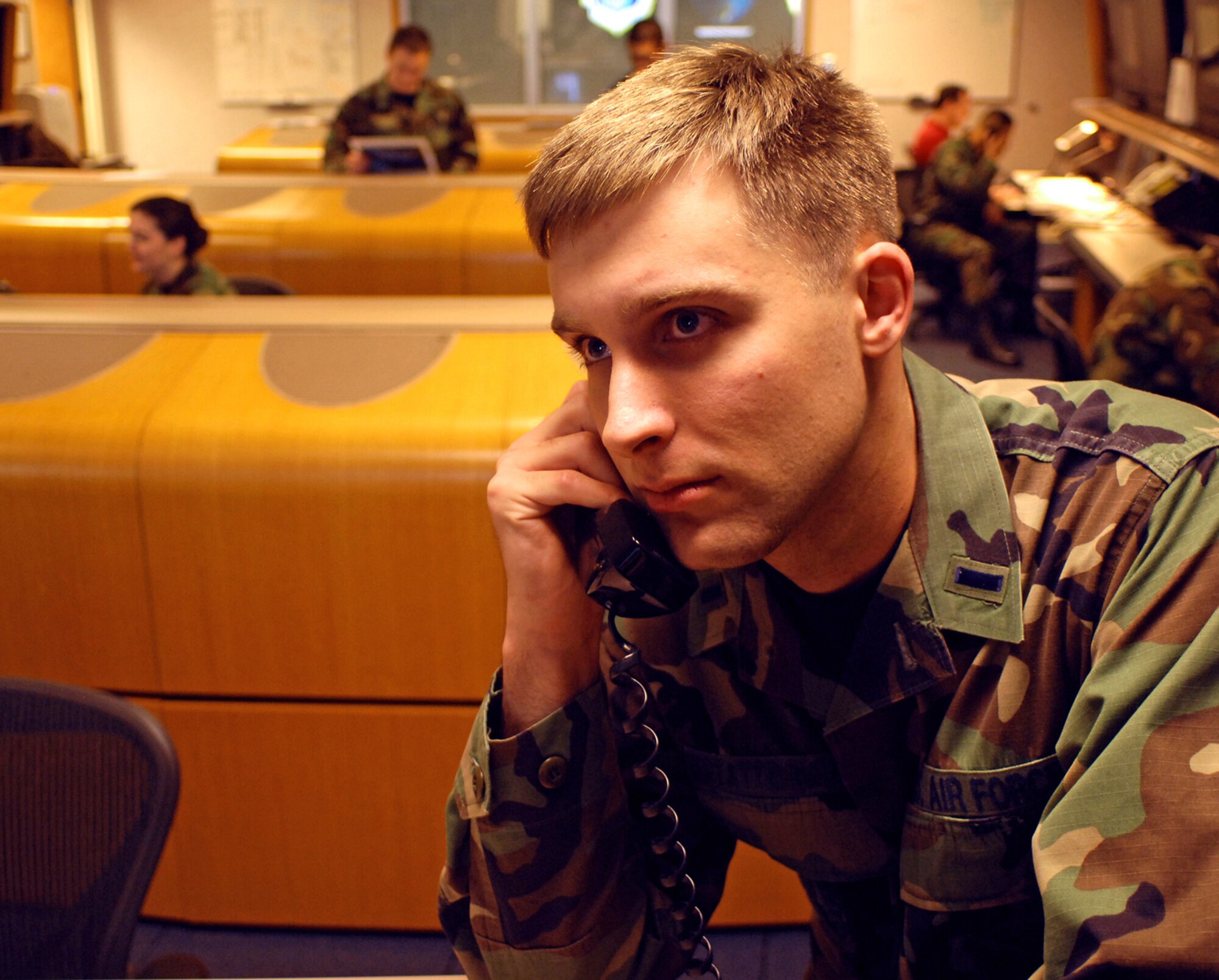 1st Lt. Greg Gstattenbauer communicates with the spacecraft and payload team before an upcoming satellite pass. (U.S. Air Force photo by Todd Berenger)