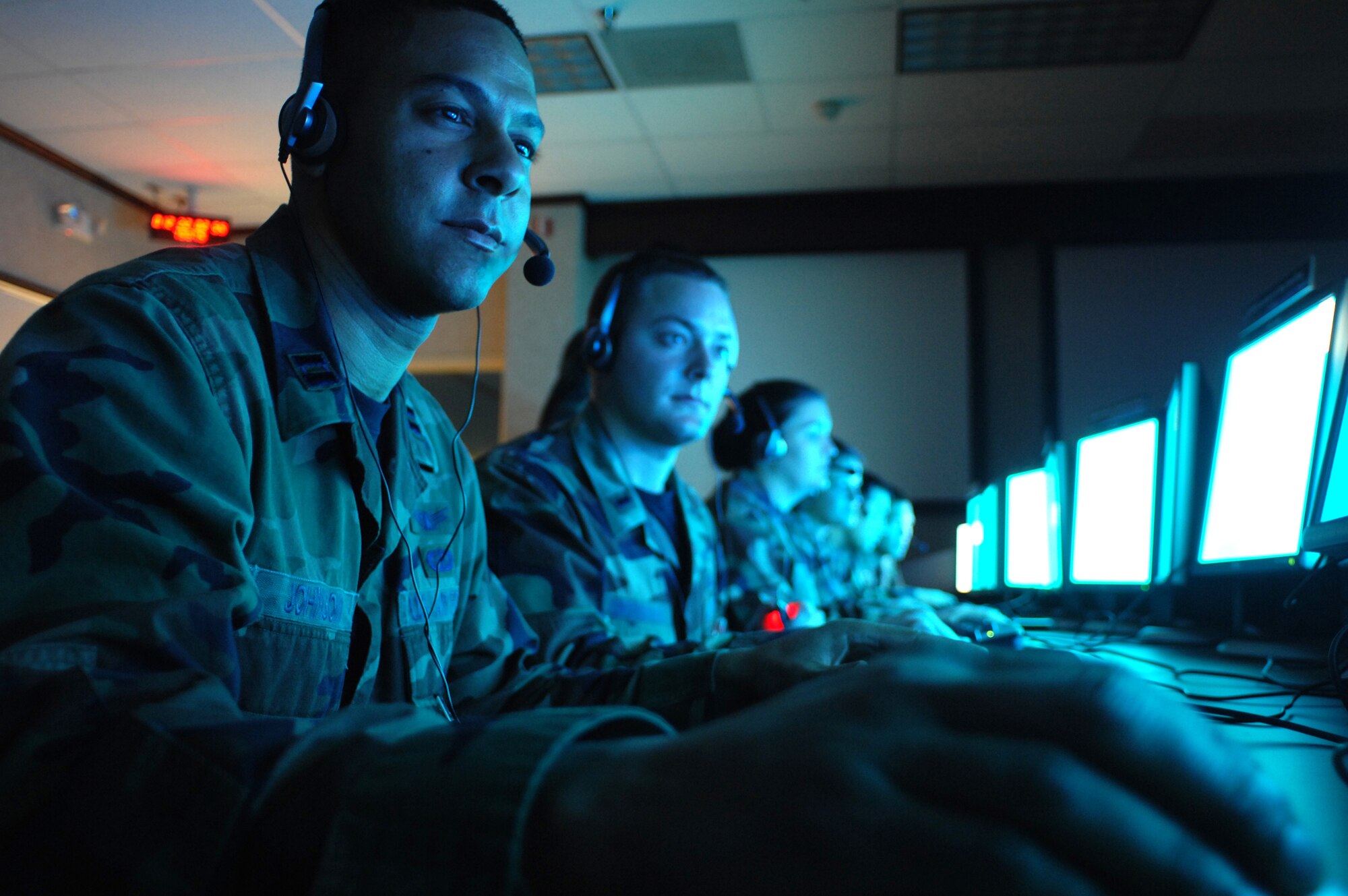 Capt. Ben Johnson and other 1st Space Test Squadron members analyze telemetry in a payload test center for one of the several satellites operated by 1st STS. The squadron is part of the Space Development and Test Wing, Kirtland AFB, N.M., which provides launch capability, space flight and on-orbit operations for the entire Department of Defense space research, development, and test and evaluation community. (U.S. Air Force photo by Todd Berenger)
