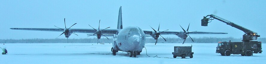 Maintenance crews perform de-icing on a C-130J during cold-weather operational test and evaluation at Eielson AFB, Alaska. (U.S. Air Force photo)                               