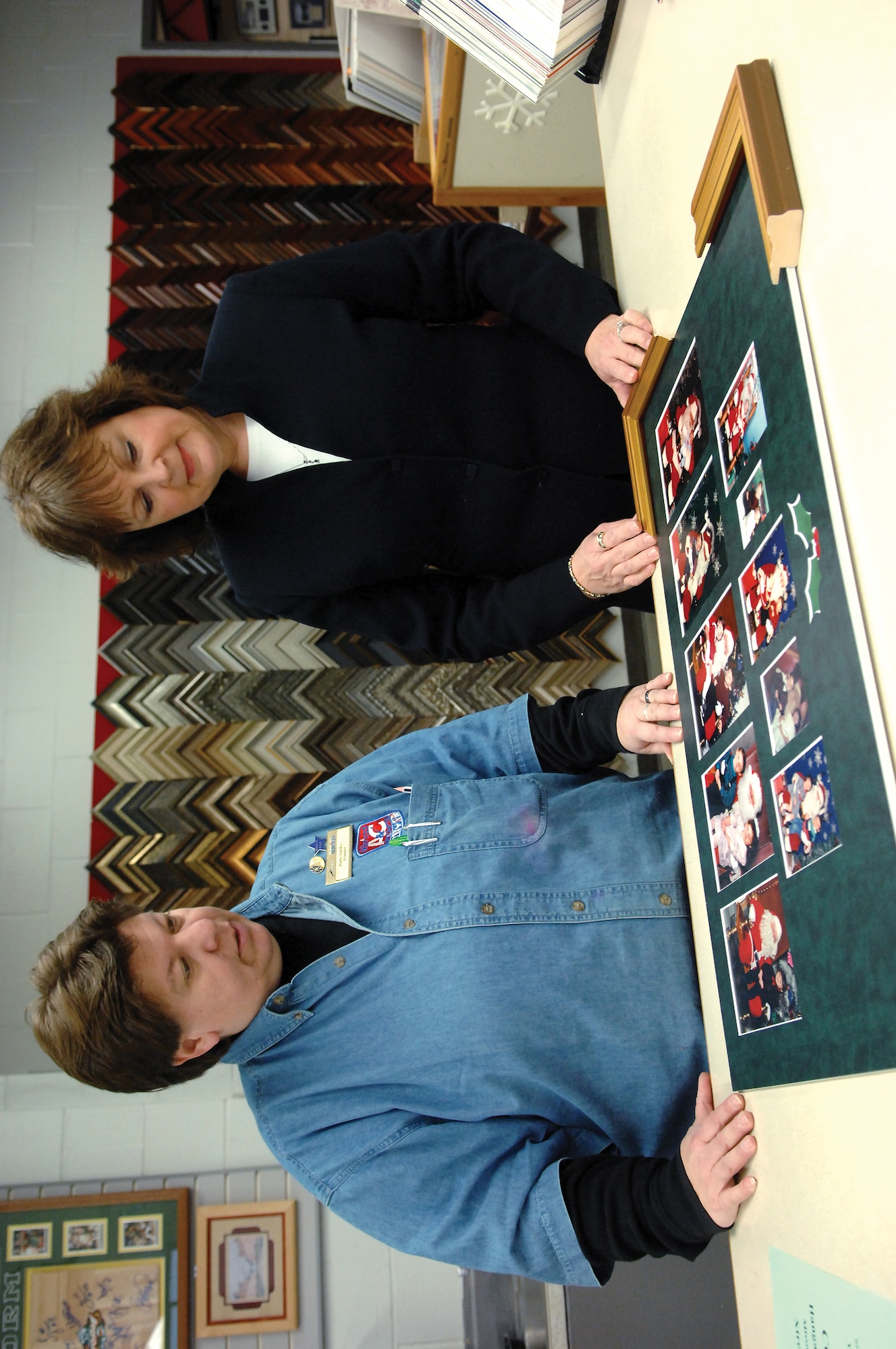 MCCHORD AIR FORCE BASE, Wash.-- Patty Valdez, 62nd Services Squadron, left, discusses projects with sales representative Darcy Beleny Jan. 18 in the arts and crafts frame shop. (U.S. Air Force Photo/Abner Guzman)

