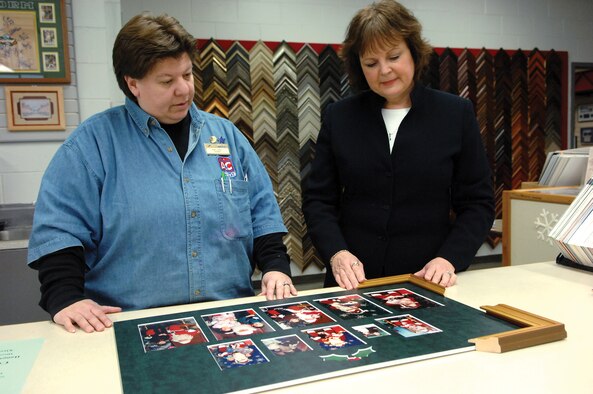 MCCHORD AIR FORCE BASE, Wash.-- Patty Valdez, 62nd Services Squadron, left, discusses projects with sales representative Darcy Beleny Jan. 18 in the arts and crafts frame shop. (U.S. Air Force Photo/Abner Guzman)


