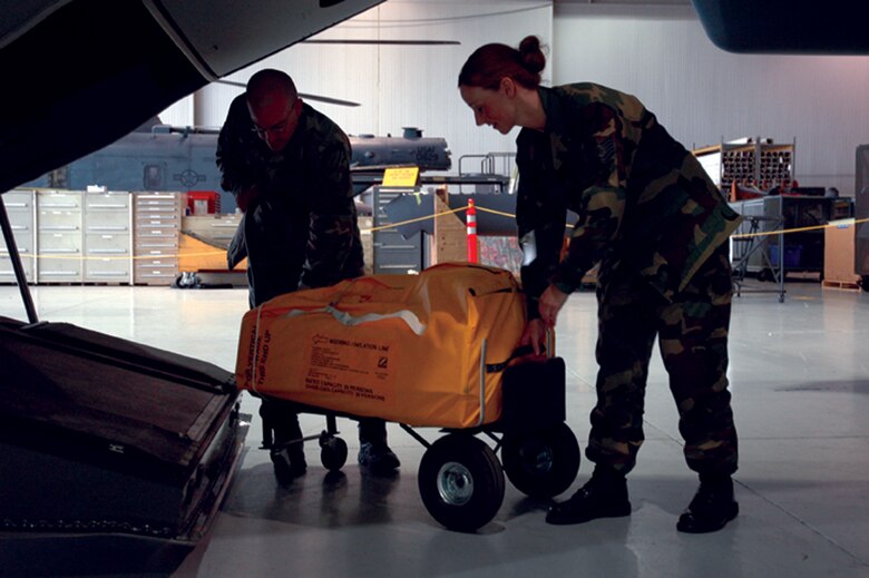 Members of the 8th AMU life support change out one of the life rafts aboard the CV-22 Osprey.  (U.S. Air Force Photograph by Jamie Haig)