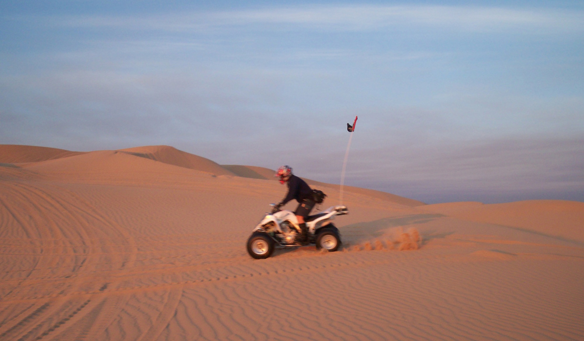 Staff Sgt. Jeffrey Souza, 944th Maintenance Squadron aerospace ground equipment technician, races across the Imperial Sand Dunes Recreation Area in Imperial County, Calif. Sergeant Souza compares riding his quad to riding a roller coaster without rails. (U.S. Air Force photo/Curtis Cool)