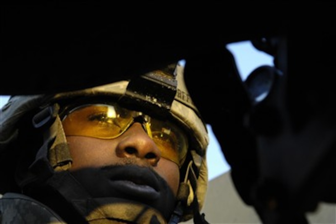 U.S. Army Spc. Quinton Green provides security from his vehicle turret while on patrol in Kahlis, Iraq, on Jan. 26, 2007.  Green is assigned to the 1st Cavalry Division. 