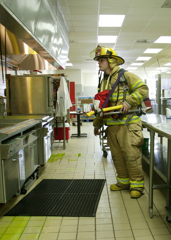Eric Smith, firefighter/paramedic, Parris Island Fire Department, investigates the scene of a fire alarm at the 1st Recruit Training Battalion Mess Hall July 23. Although it was a false alarm, the firefighters came in full force with axes ready and an ambulance on standby in case it was needed.