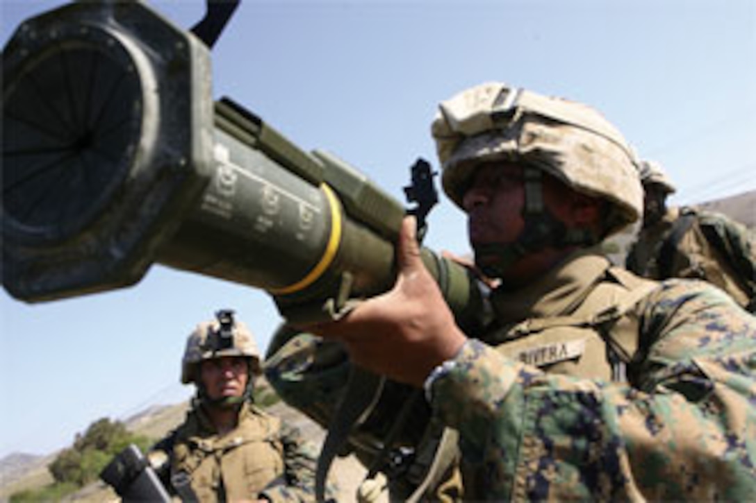 Pfc. Gustavo RiveraSaligan, rifleman, Company B, 1st Battalion, 1st Marine Regiment, does a final back-blast check prior to firing a practice round from a shoulder firing assault-rocket launcher. RiveraSaligan participated in an Infantry Skills Endurance Test squad competition here May 27, where the winning squad received a free dinner at a local steakhouse.