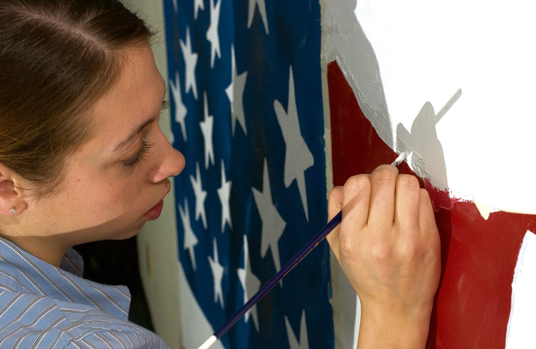 KUNSAN AIR BASE, Republic of Korea Jan. 11, 2007 -- Airman 1st Class Tara Trudell,  8th Security Forces Squadron armorer, has volunteered more than 42 hours towards painting murals in Dorm 1303. Residents of the dorm were the latest recipients of the 8th Fighter Wing's "Dorm of the Month" for best dorm on base, earning the 8th SFS $1,000 in quality of life funding. Airmen recently overhauled the aging dormitory as part of a major self-help overhaul.