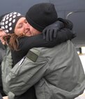MINOT AIR FORCE BASE, N.D. -- Capt. Patrick Hook, 23rd Bomb Squadron, and his wife Lisa embrace on the flightline here Jan. 28. Captain Hook, along with 19 other Minot Airmen, was met by friends and family upon arriving home from a five-month deployment to Andersen Air Force Base, Guam. (U.S. Air Force photos by Airman 1st Class Joe Rivera)
