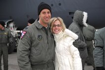 MINOT AIR FORCE BASE, N.D. -- Capt. Joe McKenna, 23rd Bomb Squadron, and his wife Maria embrace on the flightline here Jan. 28. Captain McKenna along with 19 other Minot Airmen were met by friends and family upon arriving home from a five-month deployment to Andersen Air Force Base, Guam. (U.S. Air Force photos by Airman 1st Class Joe Rivera)