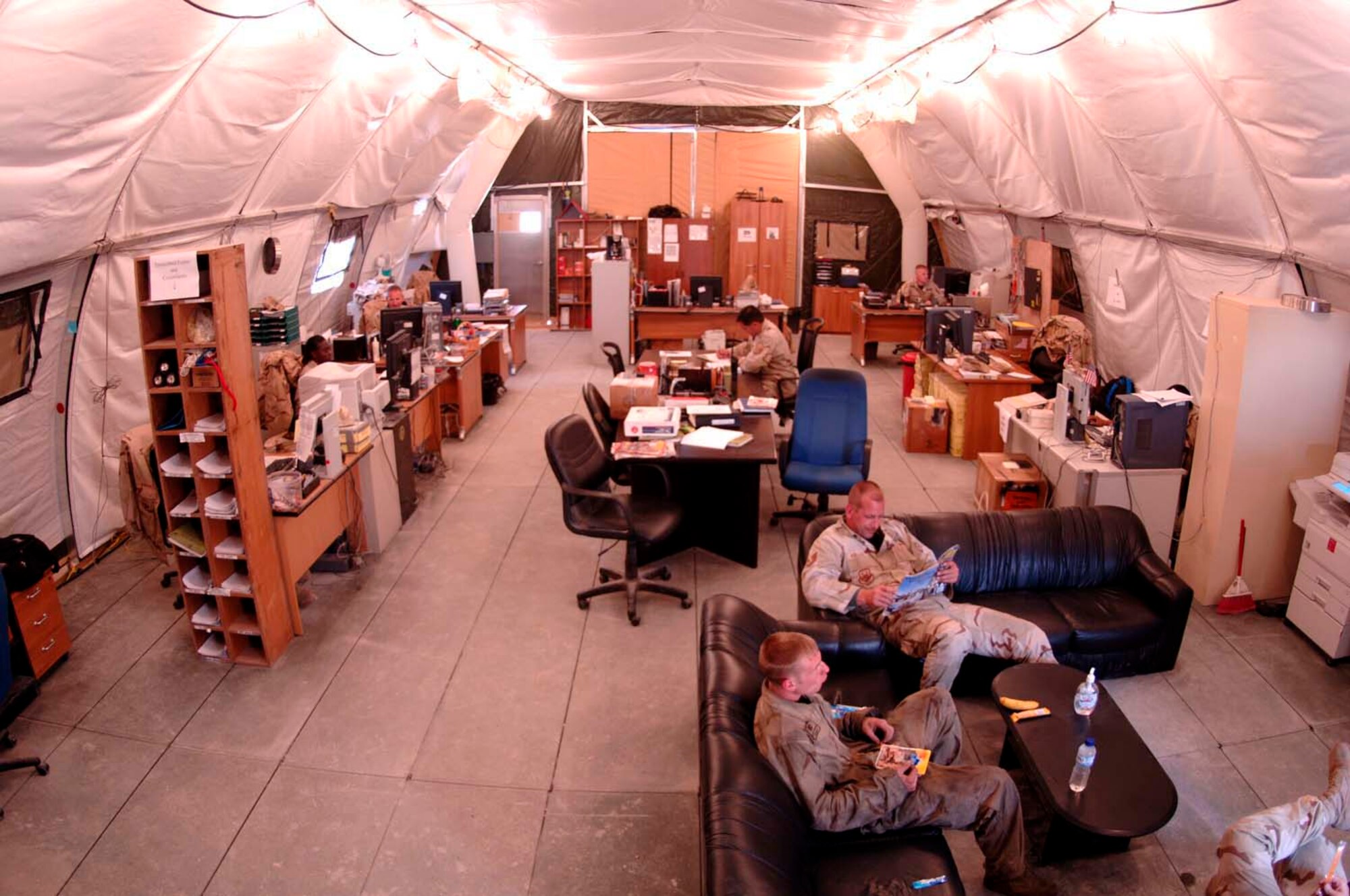 The 746th Aircraft Maintenance Unit temporarily works out of a tent while four more tents are set to be constructed along the Coalition Ramp. The new facility will be approximately double the square footage of the old complex. The 746th AMU will now have extra room to store and organized equipment and supplies. The maintainers have met a demanding flying schedule while working from their transition facility. (U.S. Air Force photo/Staff Sgt. David Miller) 
