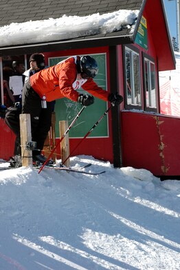 Maj. Ellen Adams, acquisition officer for Air Force Space Command contracting, pushes off from the starting house during NASTAR racing Jan. 27 at Keystone. SnoFest skiers or snowboarders could race the course free as part of the weekend’s activities. (U.S. Air Force photo by Steve Brady)