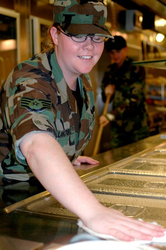 Staff Sgt. Crystal Langford cleans the dining facility serving area before loading the bins with food Jan. 23 at the La Dolce Vita Dining Facility on Aviano Air Base, Italy. Sergeant Langford is a 120th Fighter Wing food service craftsman from Great Falls, Mont. Five members of the Air National Guard from the 120th FW are working in the La Dolce Vita as part of their annual two-week duty. (U.S. Air Force photo/Senior Airman Colleen Wieman) 