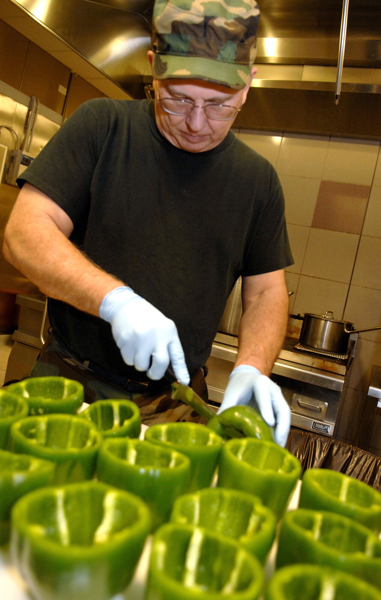 Staff Sgt. Bob Starkey prepares dinner at the La Dolce Vita Dining Facility Jan. 19 at Aviano Air Base, Italy. Base members at Aviano AB maintain two F-16 fighter squadrons to conduct regional and expeditionary operations under NATO, Supreme Allied Command Europe, or national tasking. Sergeant Starkey is deployed to Aviano AB from the 121st Fighter Wing at Great Falls, Mont. (U.S. Air Force photo/Airman 1st Class Michael S. Dorus)
