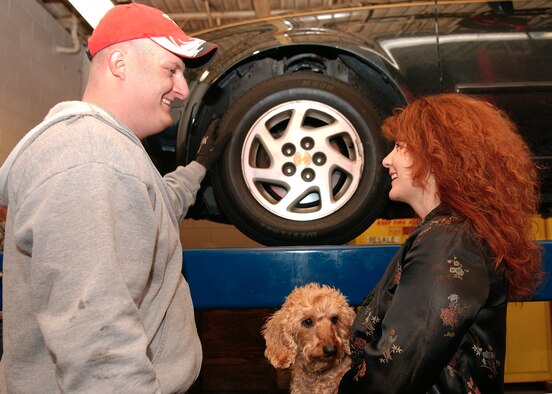 Staff Sgt. Andrew Wettstein, 314th Logistics Readiness Squadron, goes over a vehicle inspection with Kathy Atkins, wife of Lt. Col. Joseph Atkins, 314th Mission Support Squadron commander, and their dog, Frankie, at the Auto Hobby Shop Jan. 27. LRS members volunteered their Saturday to inspect vehicles for deployed or deploying Airmen's family members. Another free inspection is 9 a.m.-5 p.m. Feb.3 at the hobby shop. Contact your sponsor's first sergeant or call 987-6996 for an appointment. (Photo by Airman 1st Class Steele Britton)