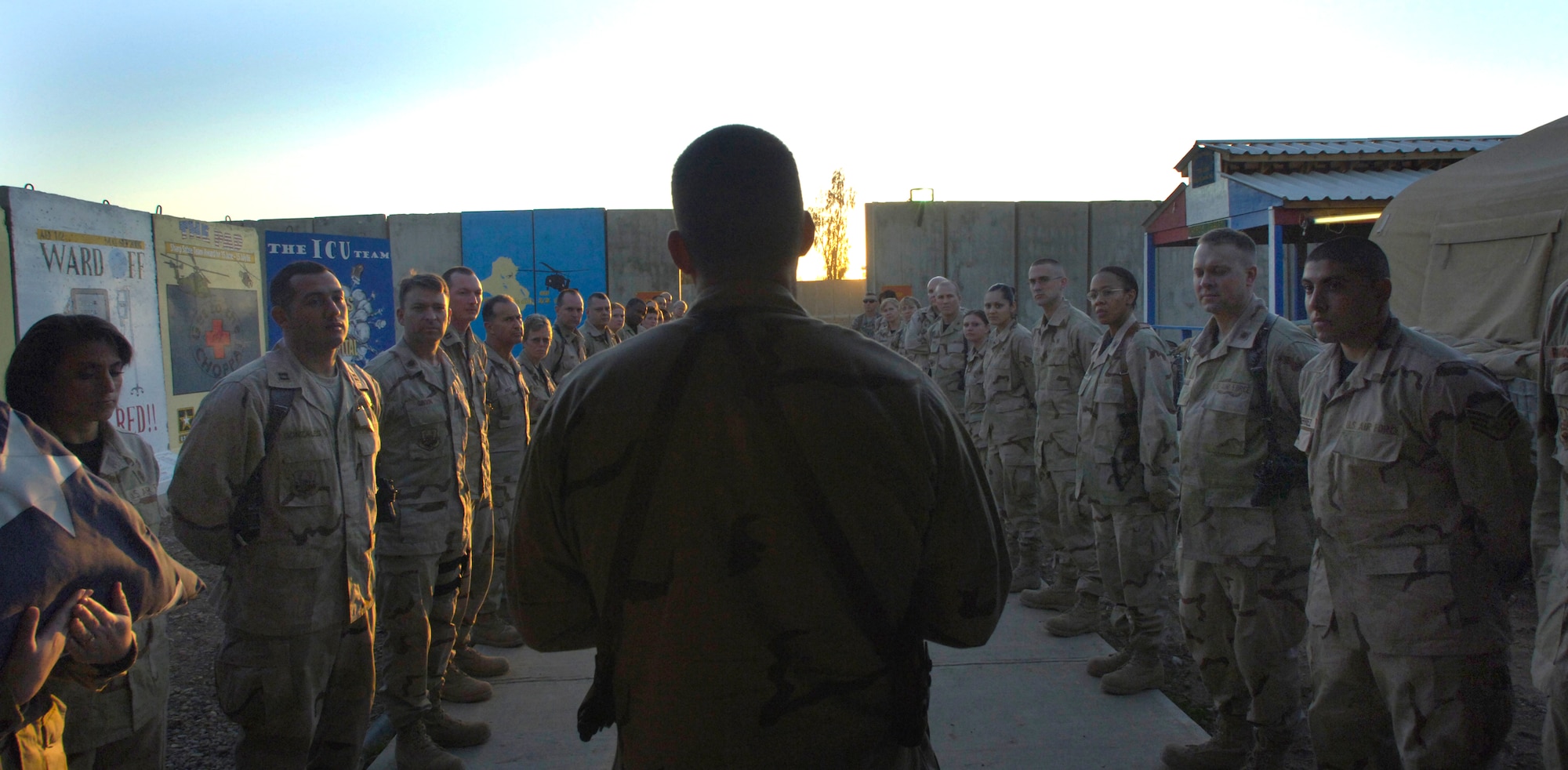 Col. Brian Masterson speaks to deployed Airmen about the accomplishments of the 332nd Expeditionary Medical Group prior to unfolding an American flag at the Hero's Highway Ceremony Jan. 22 at Balad Air Base, Iraq. The flag is posted on the inner roof a tent so injured troops can look up and know they are in an American area when brought in on litters seeking medical treatment. The medical group raised injured troops' survival rate to 98 percent. Colonel Masterson is assigned to the 332nd EMG. (U. S. Air Force photo/Airman 1st Class Nathan Doza) 
