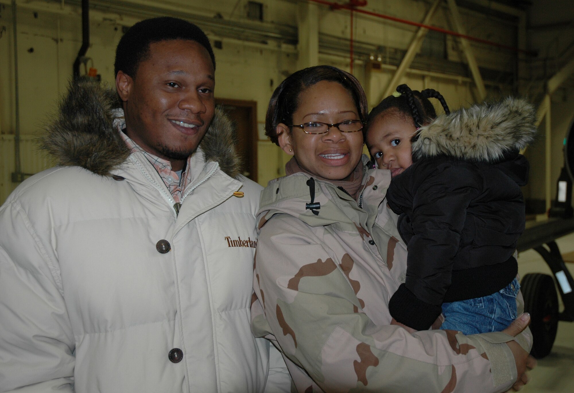 Senior Airman Yzonya Maull, 726th Air Control Squadron, is greeted by her family Jan. 26 after returning from a four-month deployment to Iraq.  While deployed, Airman Maull and other squadron members helped monitor the airspace over the battlefield, providing military leaders with a clear and accurate "picture of the area.      
